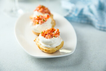 Obraz na płótnie Canvas Homemade profiteroles with salmon and cream cheese