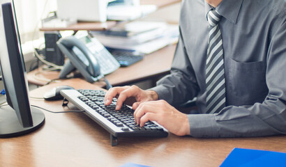 person typing on computer keyboard in office .horizontal banner business concept