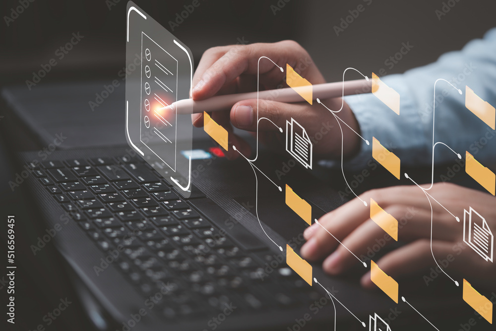 Aufkleber Businessman working on computer laptop and touching to virtual screen to check and approve document for online document database and quality management system concept.