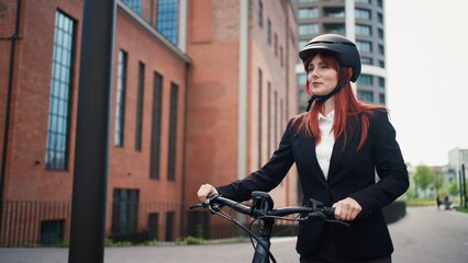 Businesswoman commuter on the way to work with bike , sustainable lifestyle concept. - Powered by Adobe