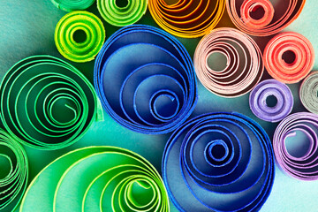 Paper quilling, or quilled paper. Spectrum of coiled paper strips in many colors. Background or...