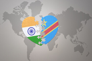 puzzle heart with the national flag of india and democratic republic of the congo on a world map background.Concept.