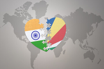 puzzle heart with the national flag of india and seychelles on a world map background.Concept.