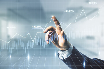 Double exposure of man hand clicks on abstract creative financial chart hologram on blurred office...