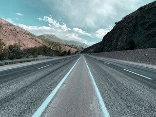 Colorful road highways. Beautiful calm route. Holiday vacation adventure. No people road with clouds. Creative colors.