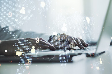 Double exposure of social network icons concept with world map and hands typing on laptop on...