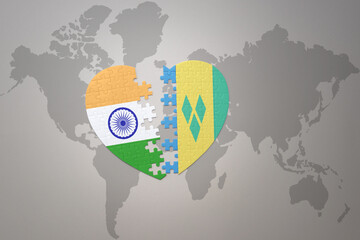 puzzle heart with the national flag of india and saint vincent and the grenadines on a world map...