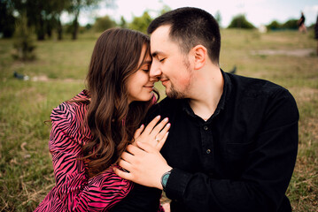 Young couple in love outdoor.Stunning sensual outdoor portrait of young stylish fashion couple posing in summer