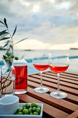 Glasses of red wine against sunset