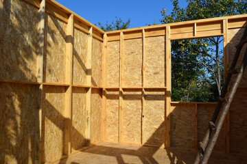 New country house construction. View from window on the garden. Wooden framework.