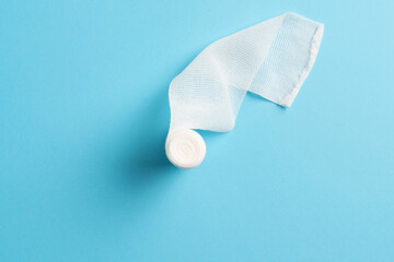 First aid, injury protecting wrapping and wound dressing concept clean cotton gauze bandage isolated on colorful background with space for sign.
