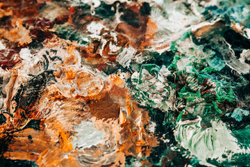 Artists multicolored oil paints on wooden palette or canvas.Orange and green. Close-up abstract background. Art concept