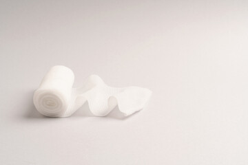 First aid, injury protecting wrapping and wound dressing concept clean cotton gauze bandage isolated on colorful background with space for sign.