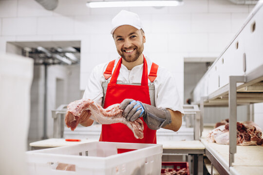 Man butcher at the freezer with meat