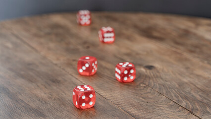 5 red casino dice on wooden background