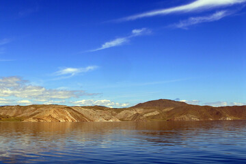 The coast of Lake Baikal. Landscape with mountains and a lake.