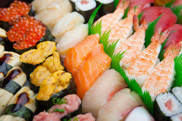 Japanese Sushi arranged on a traditional sushi tray.
