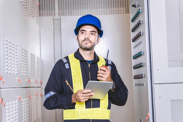 Maintenance engineer inspect relay protection system with laptop tablet computer. Electrician...