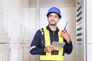 Maintenance engineer inspect relay protection system with laptop tablet computer. Electrician...