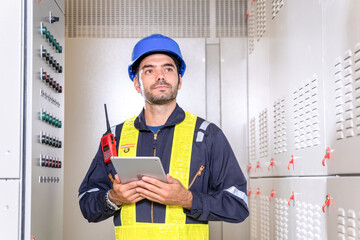 Maintenance engineer inspect relay protection system with laptop tablet computer. Electrician...