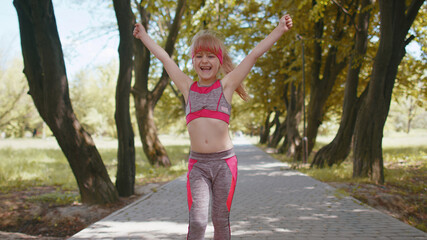 Athletic fitness sport runner child girl finishing racing competition, victory. Celebrating,...