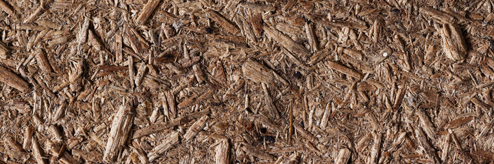 Chipboard texture. Rough particle board surface. Particleboard background. Wood building material. Close-up.
