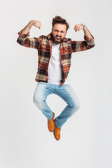 Fototapeta na wymiar handsome bearded man in hipster outfit dressed in jeans and checkered shirt