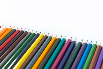 Fototapeta premium Set of colored watercolor pencils arranged in a semicircle isolated on a white background