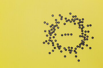 The inscription Idea from the letters of the beads scattered on a yellow background
