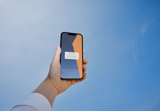 Mockup of Smartphone with Hand Against the Blue Sky