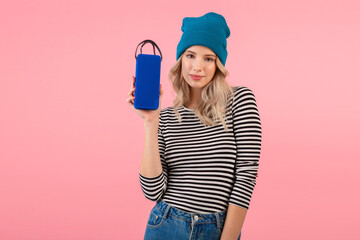 young woman holding music speaker