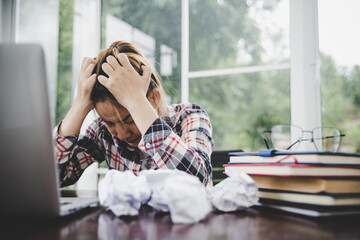 Young frustrated woman working at office