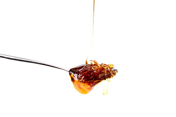 Tasty honey dripping from a teaspoon. Healthy food