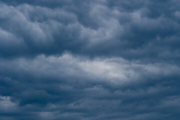 Naklejka na ściany i meble Strong dark storm rain clouds over the sky.