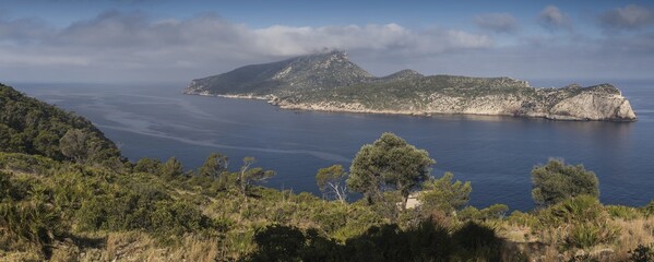 Sa Dragonera is an uninhabited island in the Balearic Islands in Spain, near the west coast of Mallorca. Summer, day, sun, morning light, trees, sea.