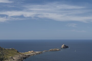 Rocks Punta del Toro, Beautiful nature, sea, in the background boat, Mallorca, Balearic Islands, Spain.