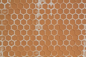 The close-up of detailed dirty texture reverse side of the ceramic tile. Rough embossed lattice. Concept of repair. Backside decoration interior. Relief geometric honeycombs pattern. Flatlay, mock up