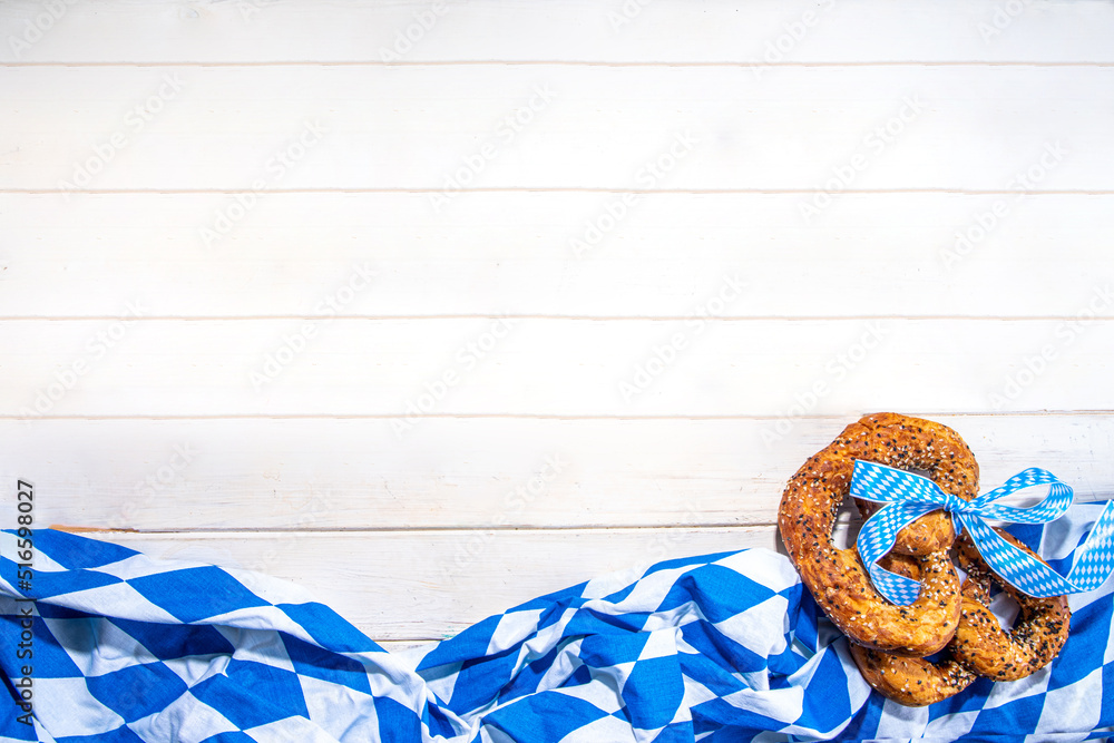 Wall mural Oktoberfest holiday background, menu mockup. Bavaria flag oktoberfest festival napkin, pretzel, beer bottle and mug on white wooden background, copy space top view