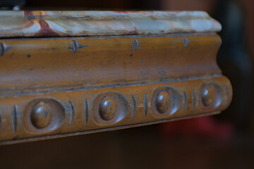 wooden table with incrustations and carvings, polished onyx stone surface table top