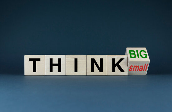 Think Big or Think Small. The cubes form the choice words Think Big or Think Small.