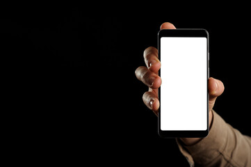 mock up Smartphone in male hand on black background