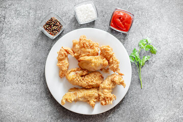 Chicken strips on stone background