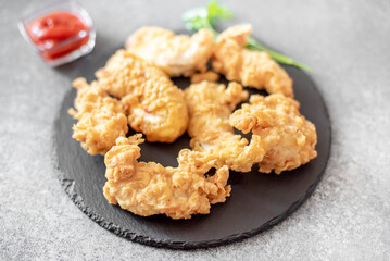 Chicken strips on stone background
