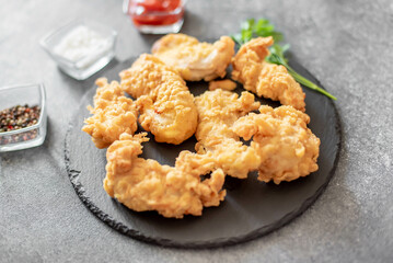 Chicken strips on stone background
