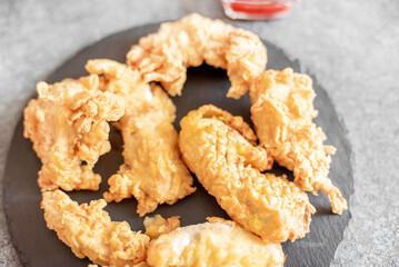 Chicken strips on stone background