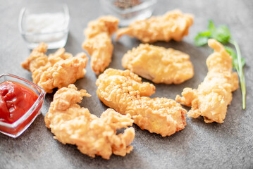 Chicken strips on stone background