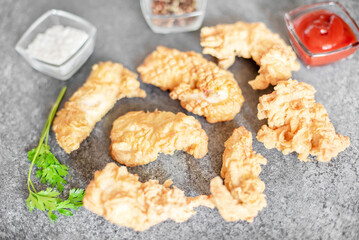 Chicken strips on stone background