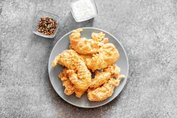 Chicken strips on stone background