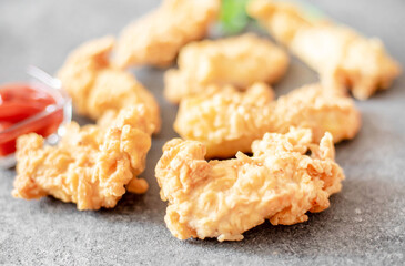 Chicken strips on stone background