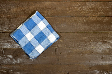 blue and white checkered napkin isolated on wood table